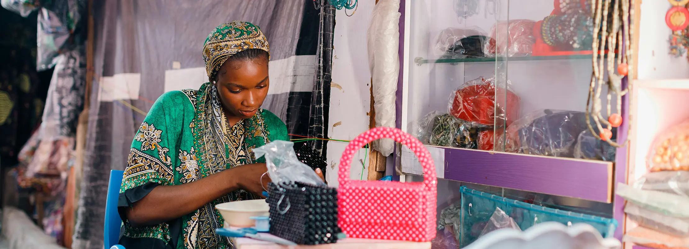 A young woman making handbags in a workshop studio